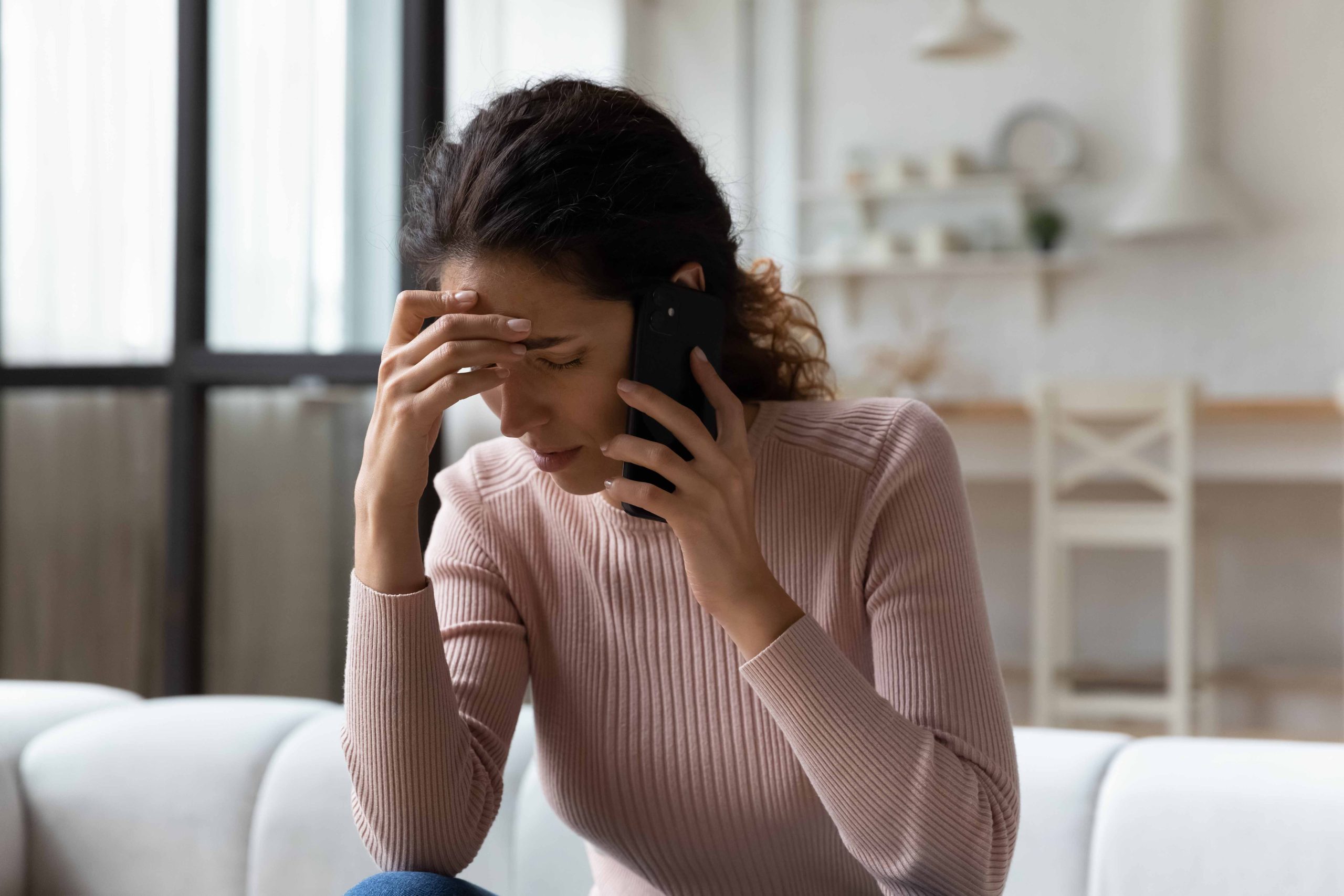 Woman on phone looking upset